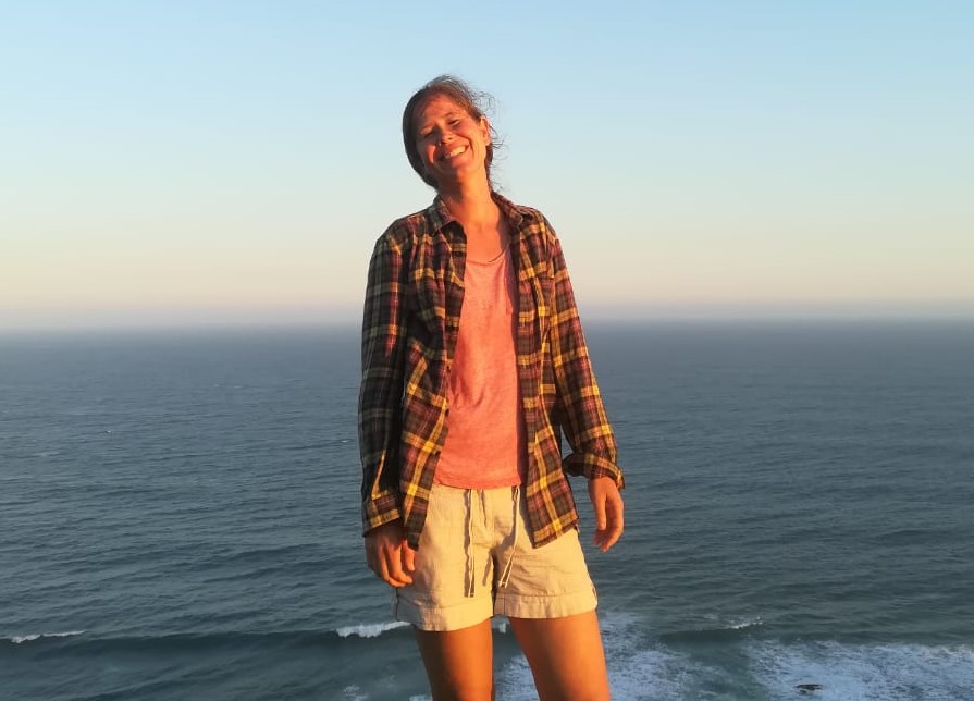 Ingrid smiling beside the sea